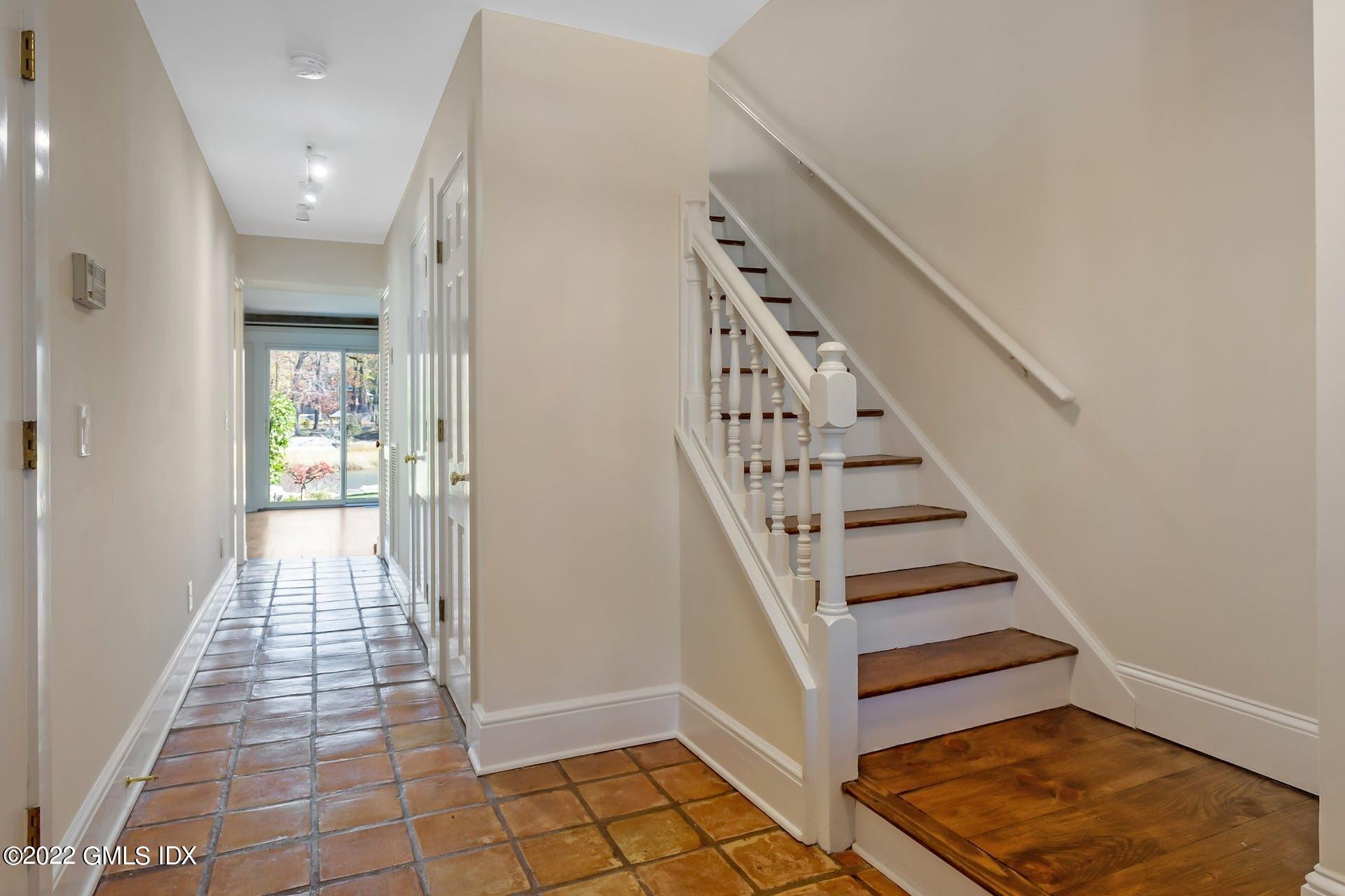 603 Steamboat Road, Unit 6 Greenwich, CT 06830 - Photo 6 of 40 a view of entryway with wooden floor and stairs
