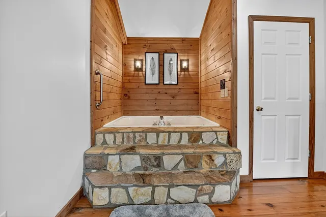 a view of a deck with a floor to ceiling window and a yard