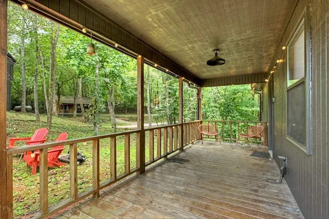 a kitchen with stainless steel appliances granite countertop a stove top oven a sink dishwasher and a refrigerator with wooden cabinets