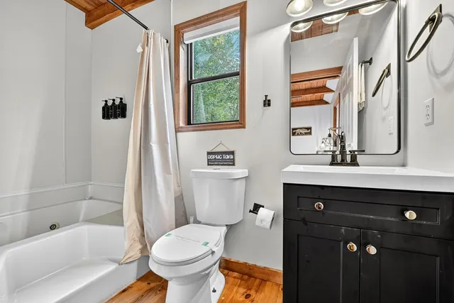 a view of a house with a yard and deck area