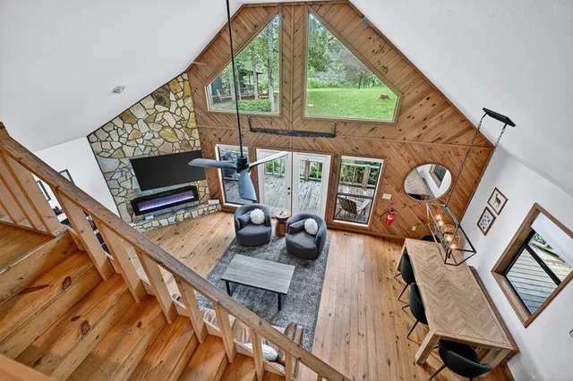 a kitchen with a refrigerator a stove dining table and chairs