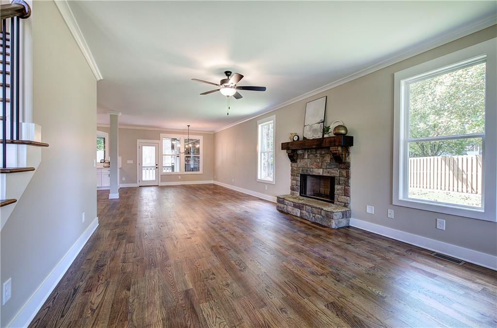 10 Dove Pointe Euharlee, GA 30145 - Photo 12 of 61 a view of a big room with wooden floor a fire place and windows