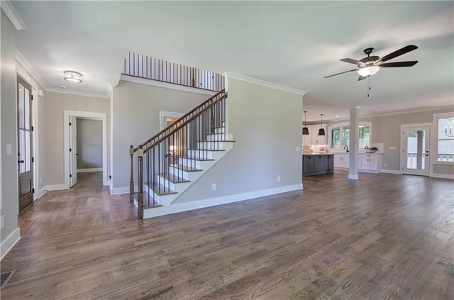 a large kitchen with stainless steel appliances kitchen island granite countertop a large cabinets a sink and a counter space