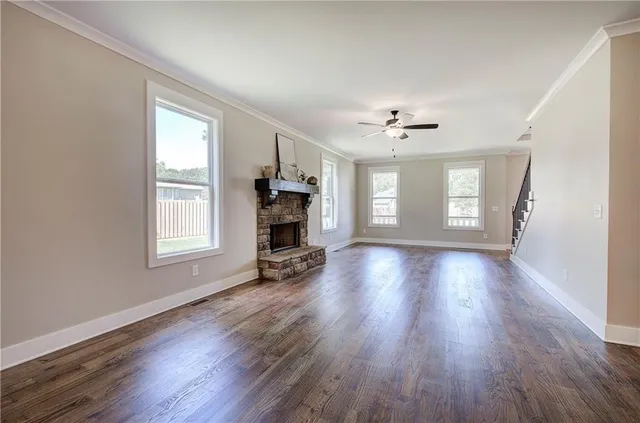 a large kitchen with stainless steel appliances granite countertop a sink and dishwasher with white cabinets