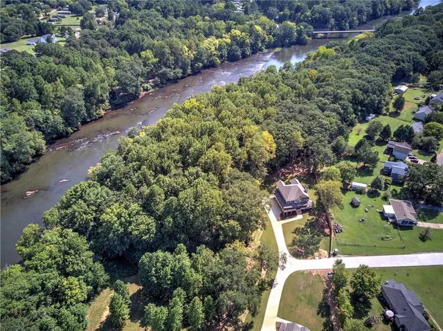 an aerial view of a residential houses with outdoor space