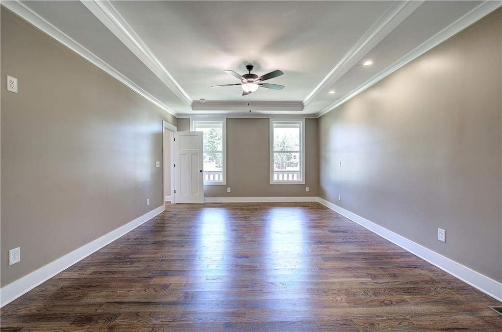 10 Dove Pointe Euharlee, GA 30145 - Photo 45 of 61 an empty room with wooden floor chandelier fan and windows
