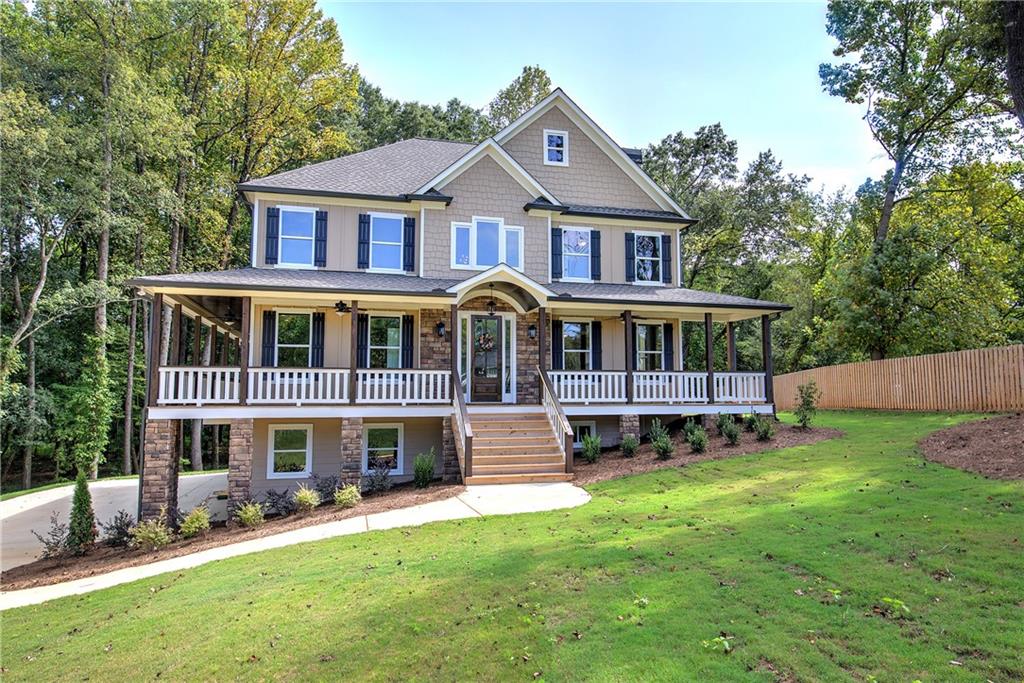 10 Dove Pointe Euharlee, GA 30145 - Photo 7 of 61 a front view of a house with a yard table and chairs