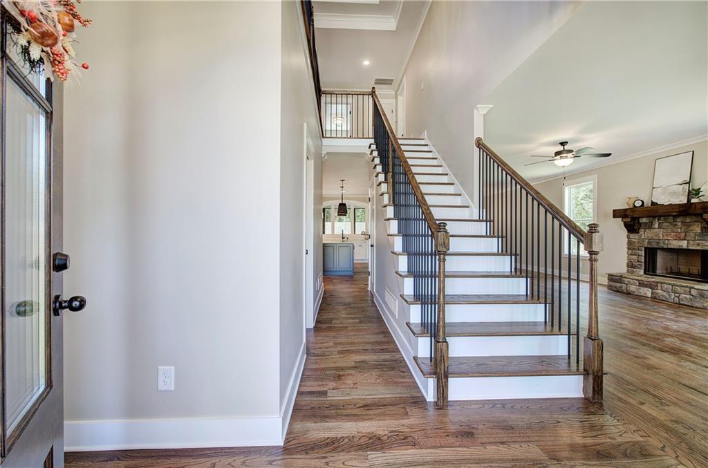 10 Dove Pointe Euharlee, GA 30145 - Photo 10 of 61 a view of a hallway to a livingroom with wooden floor and stairs
