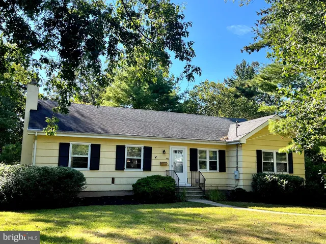 a view of house with garden and swimming pool