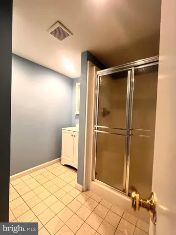 a view of a kitchen with granite countertop a sink and a refrigerator
