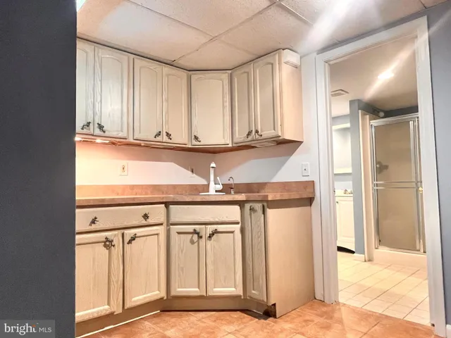 an empty room with wooden floor fireplace and windows