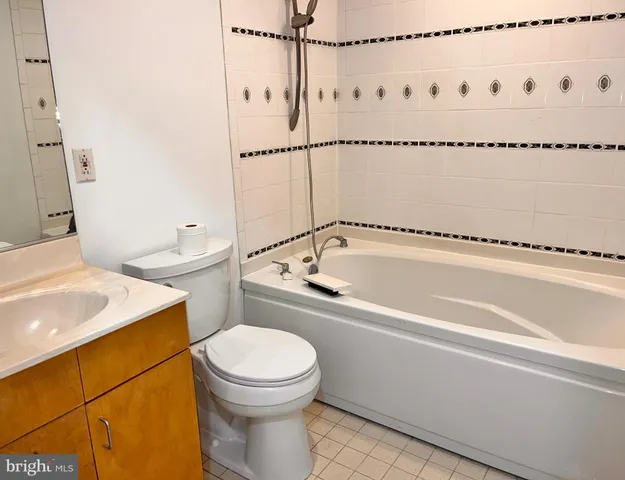 a bathroom with a sink a toilet and a shower