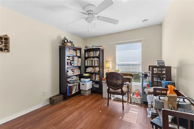 a view of a workspace with furniture and a window