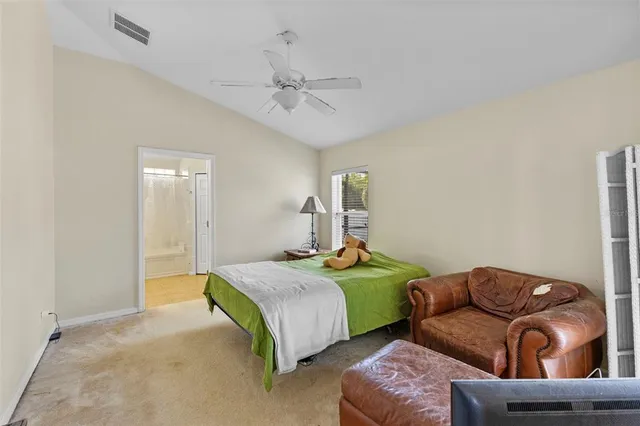a bedroom with two beds and ceiling fan