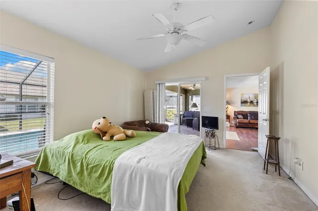 a bedroom with a bed couch and a window