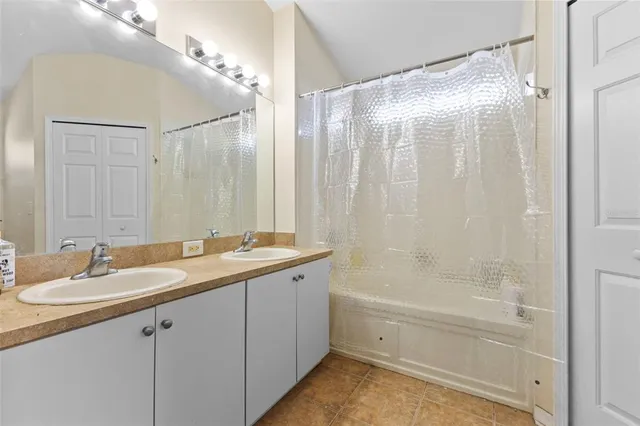 a bathroom with a granite countertop sink a toilet and shower