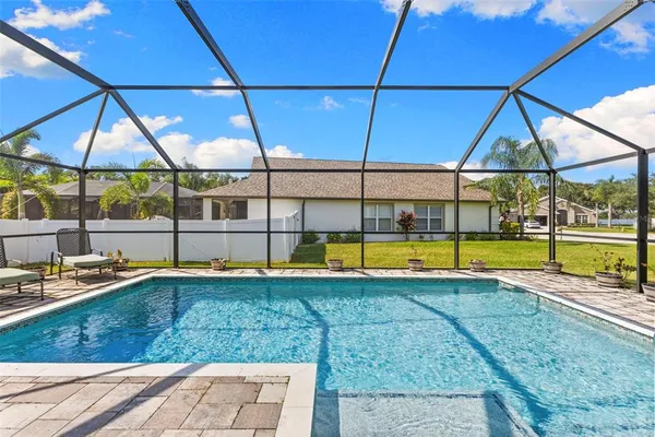 a view of a backyard with swimming pool