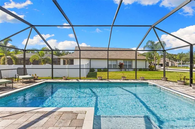 a view of a backyard with swimming pool