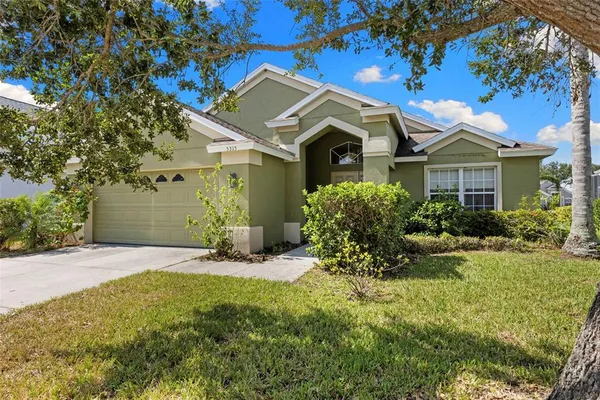 a front view of a house with a yard garage and outdoor seating
