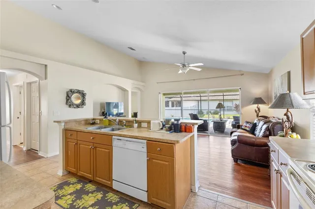 a very nice looking living room with a large window and wooden floor
