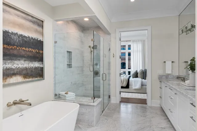 a bathroom with a sink a toilet a mirror and shower