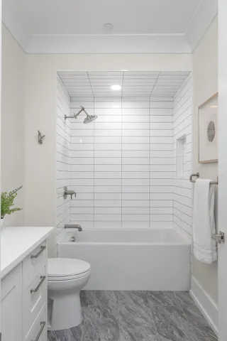 a living room with furniture large windows and wooden floor