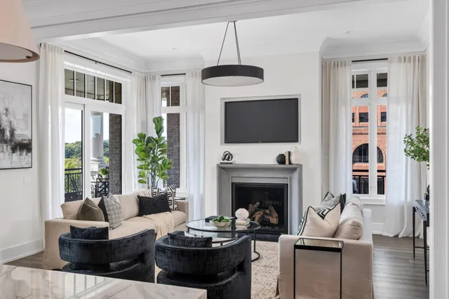 a living room with furniture a fireplace and a flat screen tv