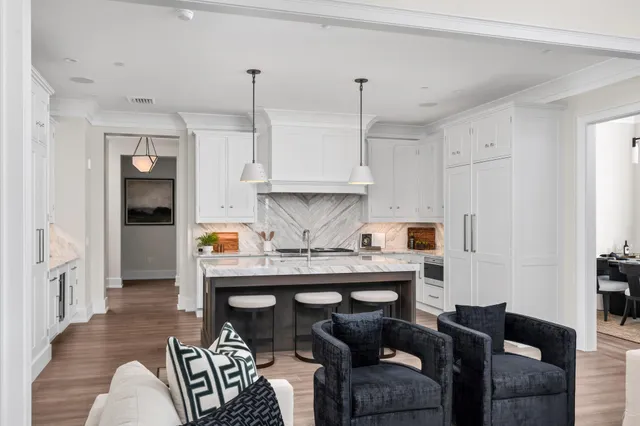 a living room with furniture and a chandelier