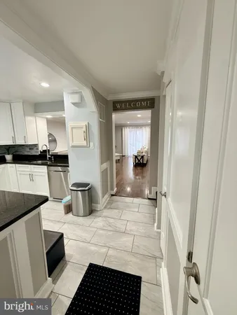 a kitchen with stainless steel appliances kitchen island granite countertop a sink and cabinets