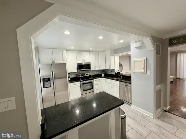 a kitchen with stainless steel appliances a refrigerator sink and stove