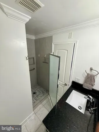 a white toilet sitting next to a wooden cabinet