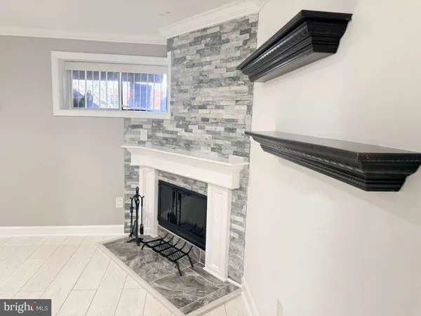 a view of empty room with a fireplace and wooden floor