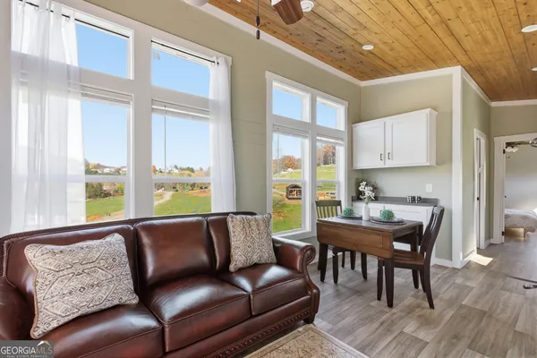 a view of a livingroom with furniture and a window