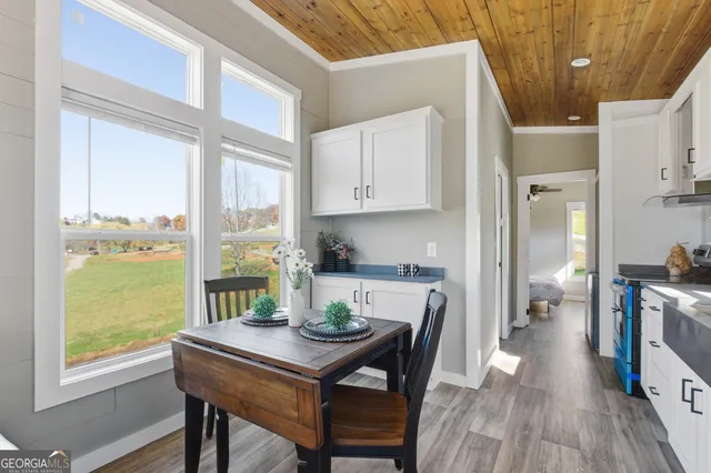 a view of a dining room with furniture and wooden floor