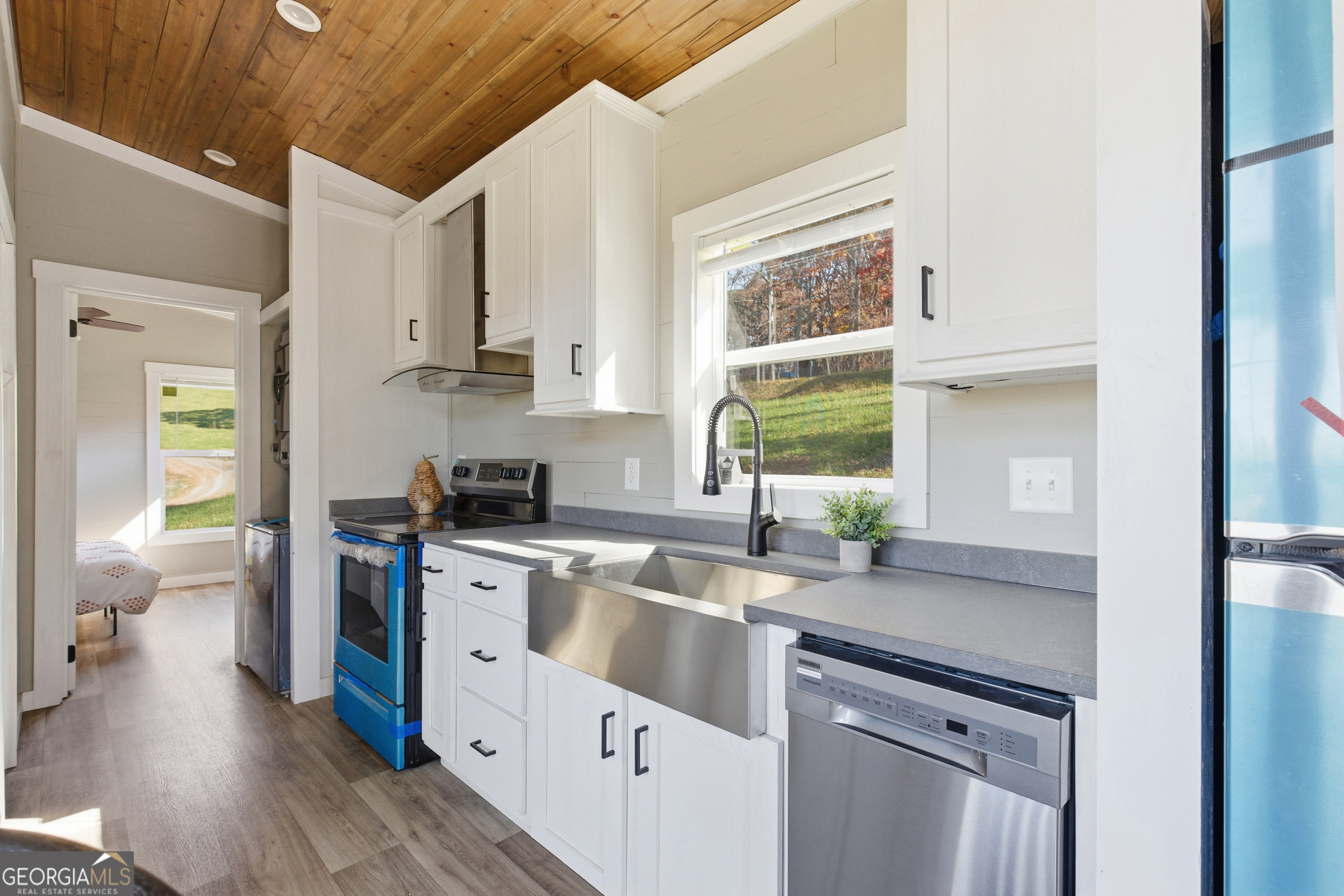 527 Saunders Road Franklin, NC 28734 - Photo 10 of 16 a kitchen with a sink cabinets stainless steel appliances and a window