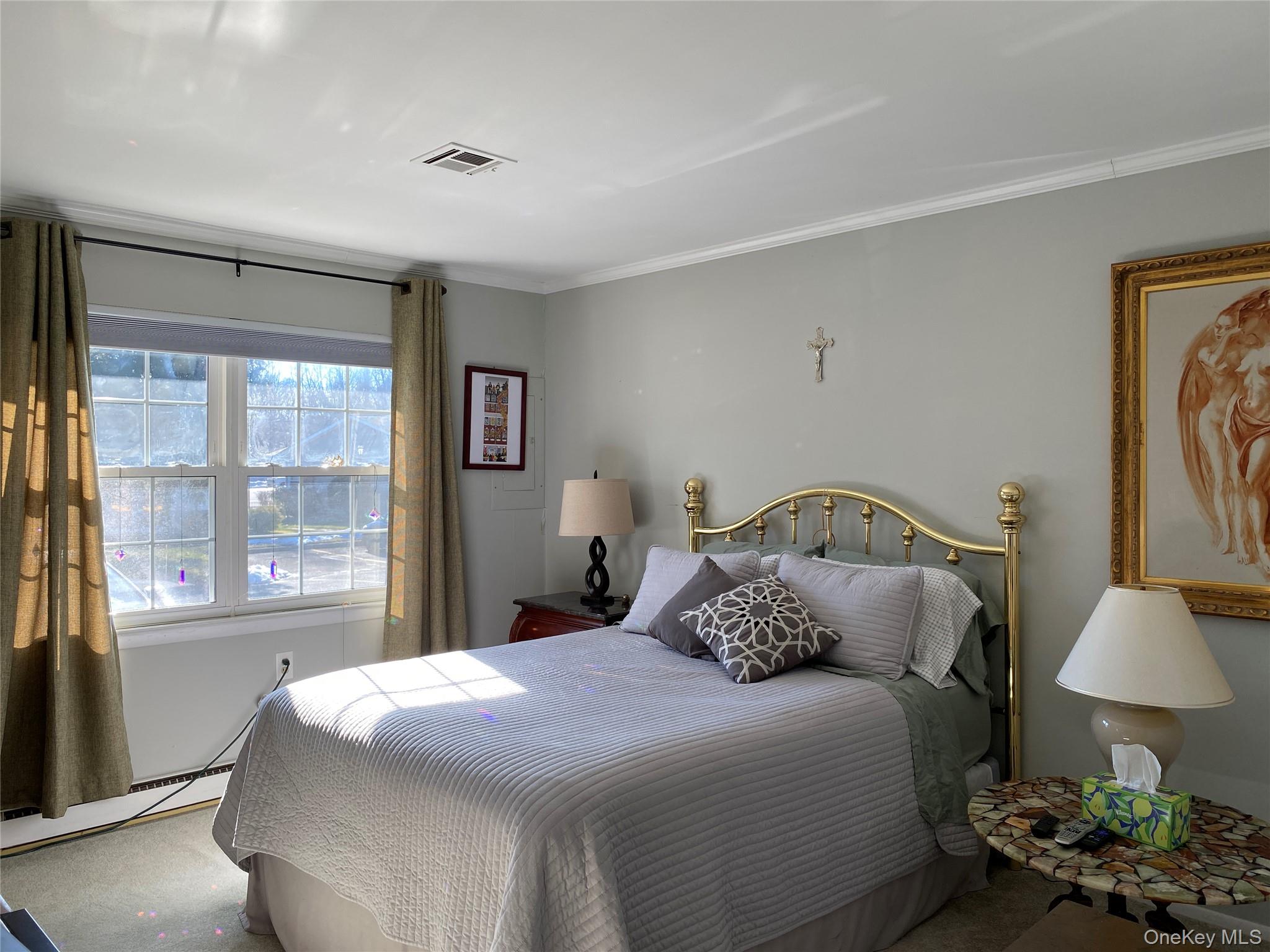 274 Berwick Court, Unit A Ridge, NY 11961 - Photo 21 of 26 a bedroom with a bed and a lamp on table
