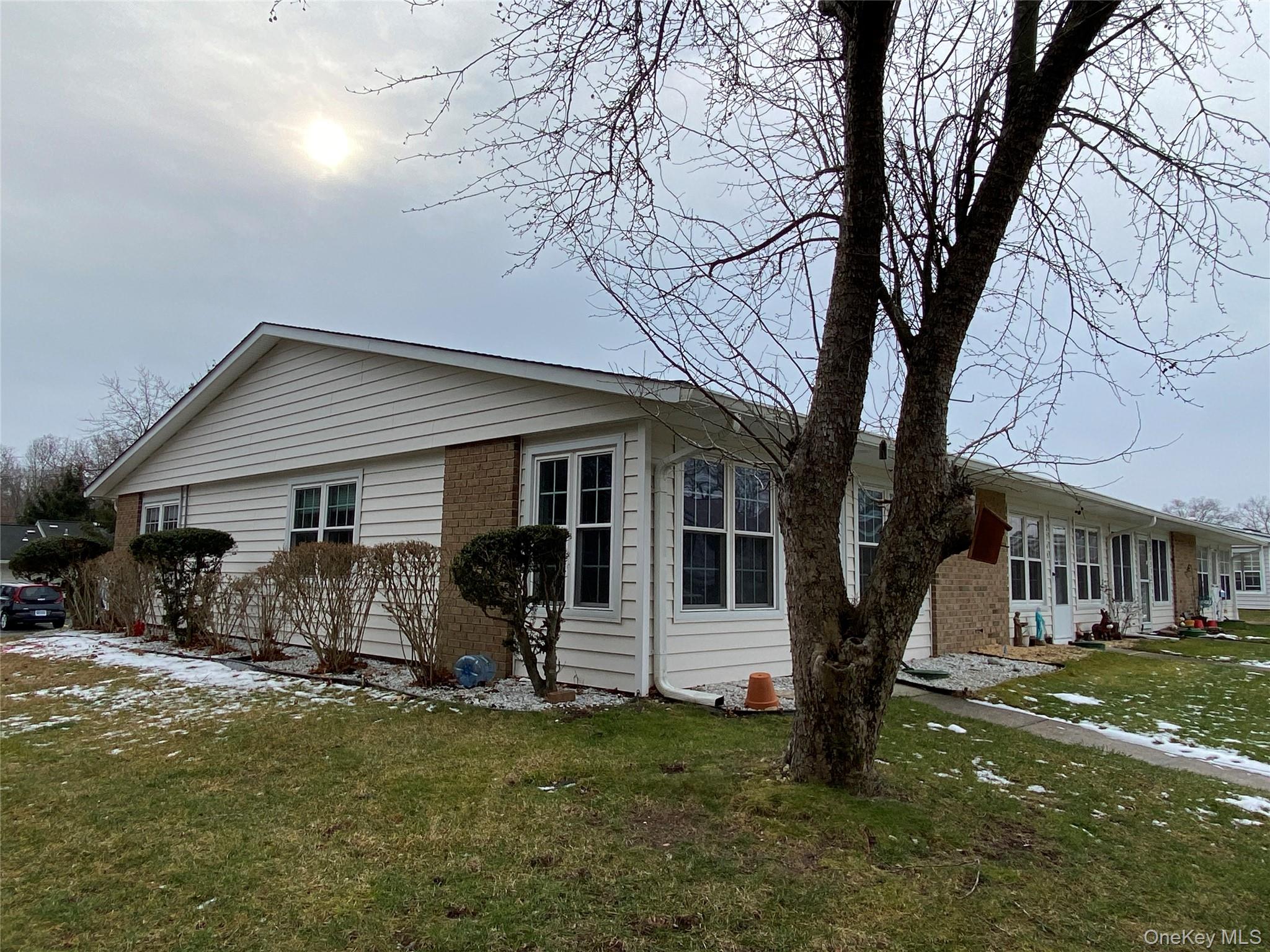274 Berwick Court, Unit A Ridge, NY 11961 - Photo 3 of 26 a view of a house with backyard and a tree
