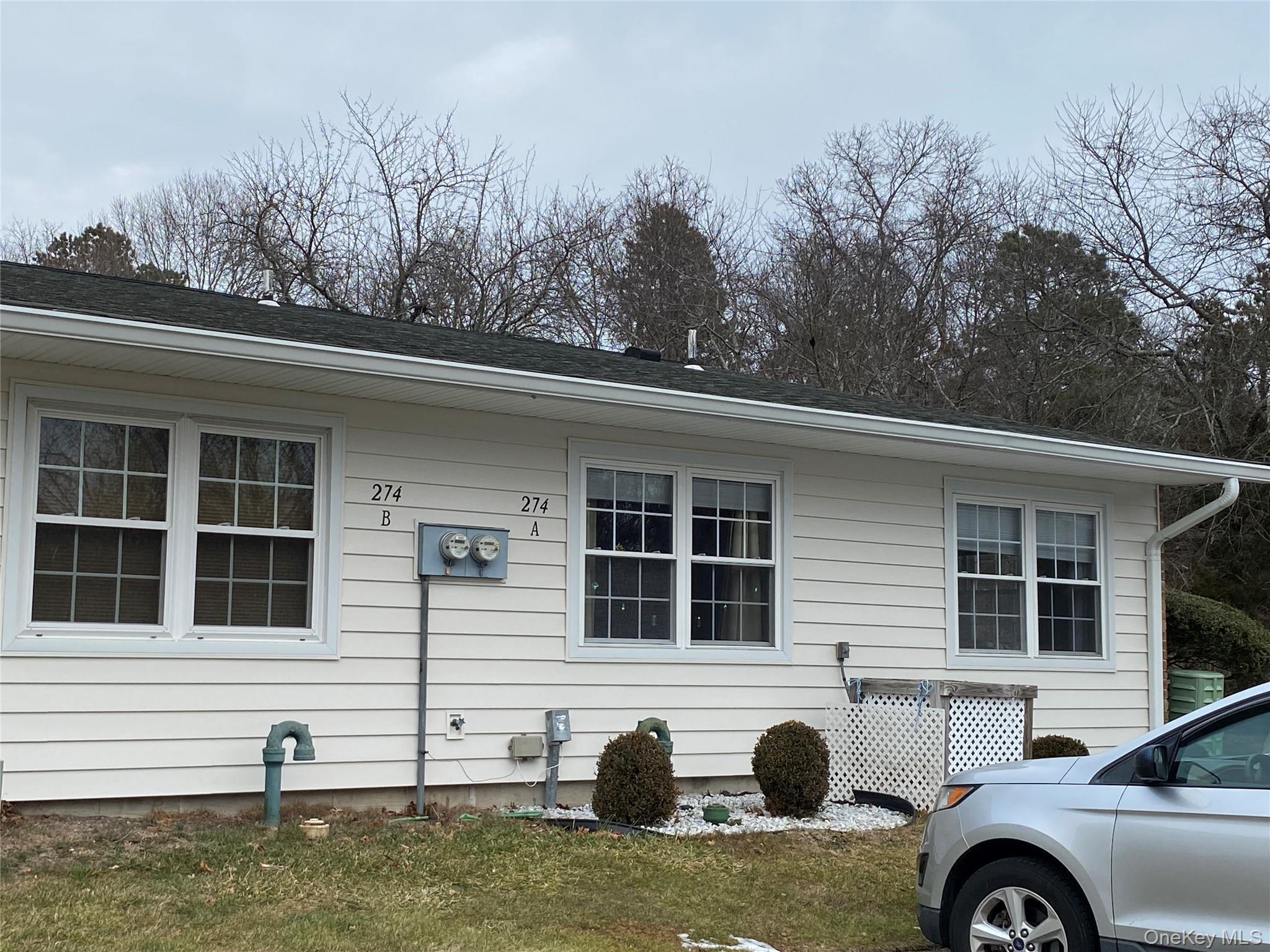 274 Berwick Court, Unit A Ridge, NY 11961 - Photo 5 of 26 a front view of a house with garden