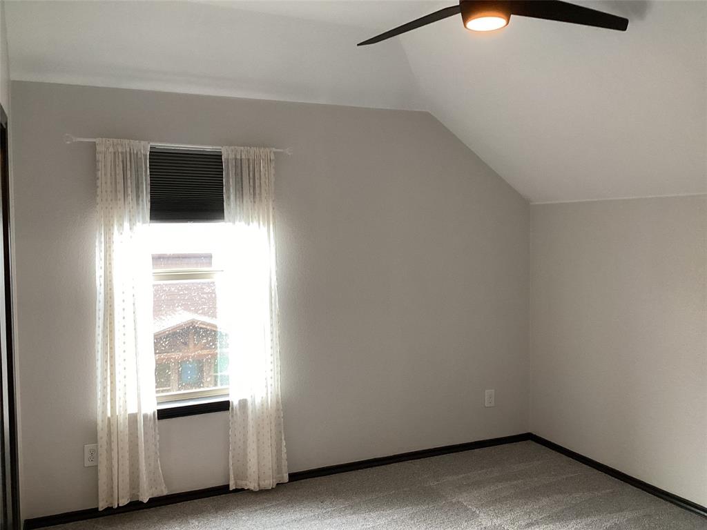 10320 Point Lobos Trail Fort Worth, TX 76177 - Photo 27 of 33 Interior room featuring a single window, sloped ceiling, and a ceiling fan with integrated lighting