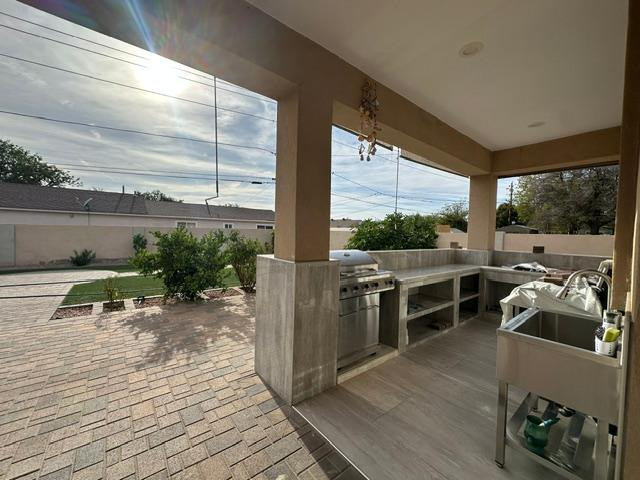 6830 North 14th Street Phoenix, AZ 85014 - Photo 9 of 28 a living room with furniture a flat screen tv and floor to ceiling window