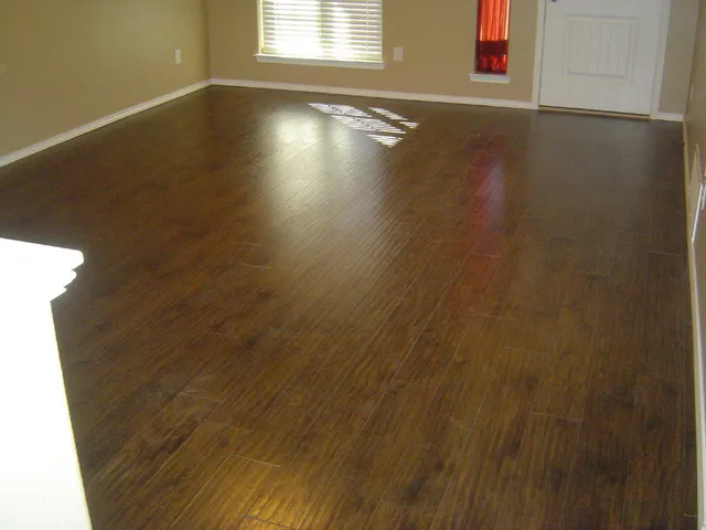 a view of a livingroom with wooden floor and a window