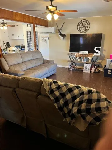 a living room with furniture and a chandelier