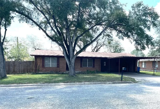 a front view of house with a garden