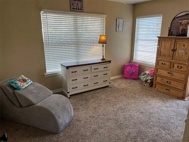 a view of a livingroom with furniture and a window