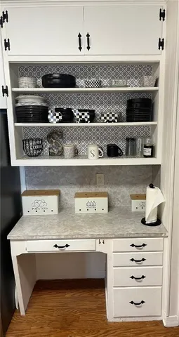 a view of white cabinets with a sink