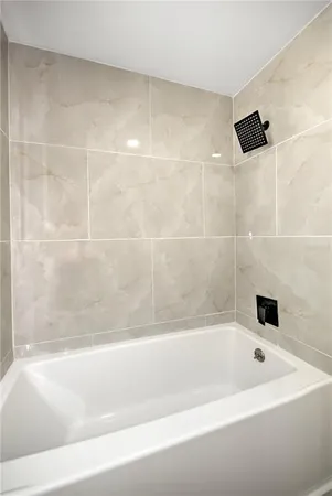 a bathroom with a bathtub and a shower