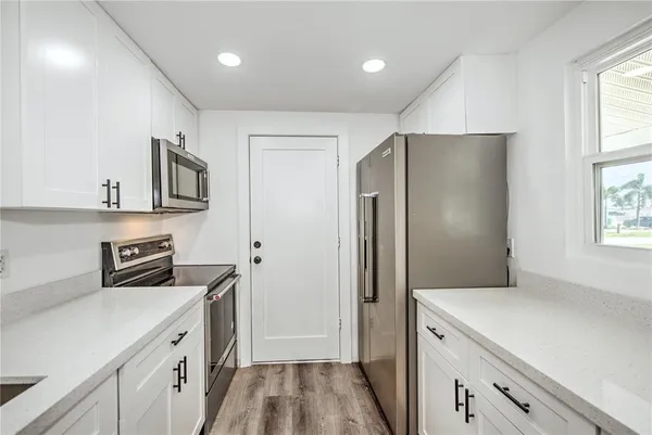 a kitchen with stainless steel appliances a refrigerator sink and cabinets