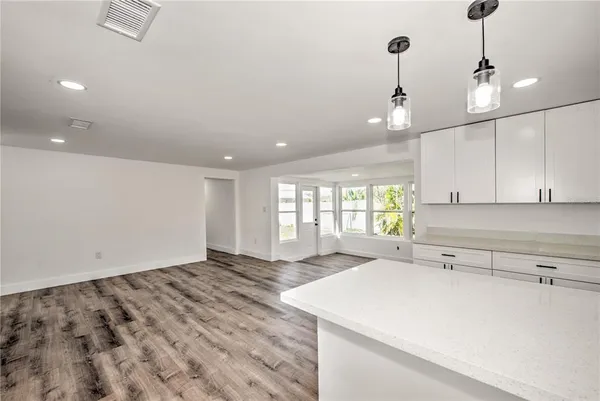 a view of a kitchen with a sink and window