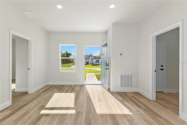 a view of a bedroom with wooden floor and a bed