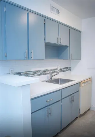 a kitchen with a sink cabinets and a sink